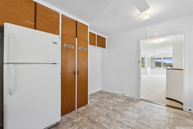 99-426 Poaha Pl, Aiea, HI 96701 - kitchen with freestanding refrigerator, ceiling fan, stone finish flooring, and brown cabinets