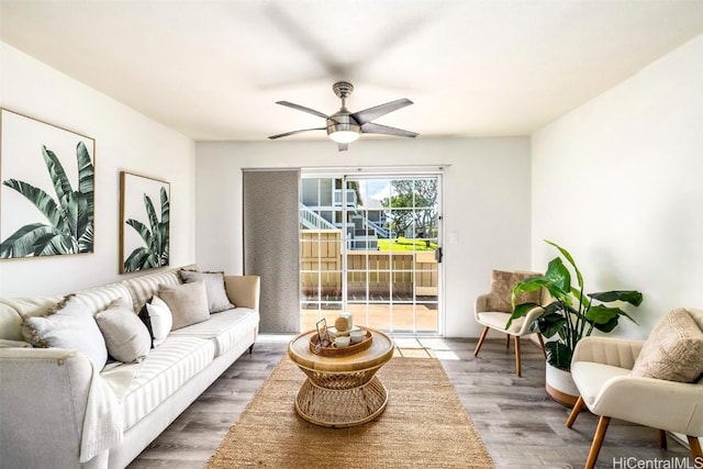 living area featuring ceiling fan and wood finished floors