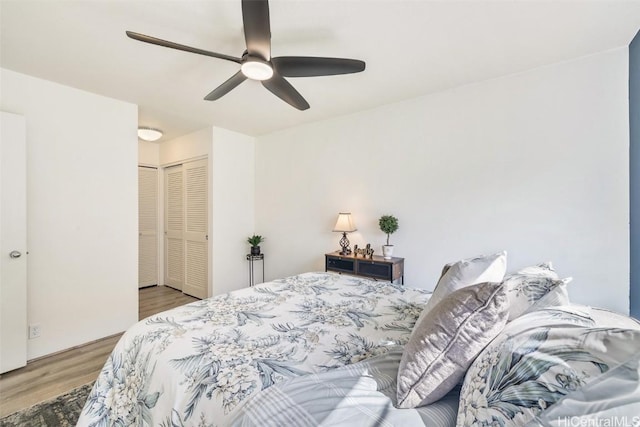 bedroom with ceiling fan, a closet, and wood finished floors