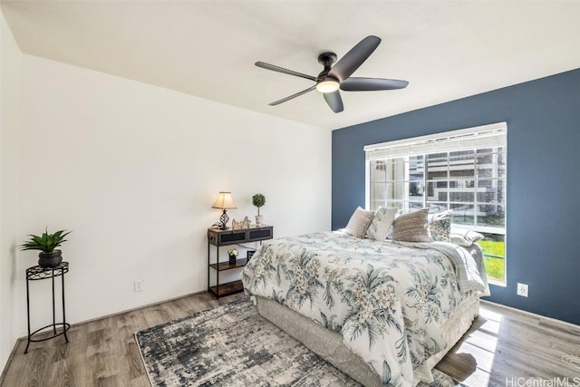 bedroom with wood finished floors and a ceiling fan