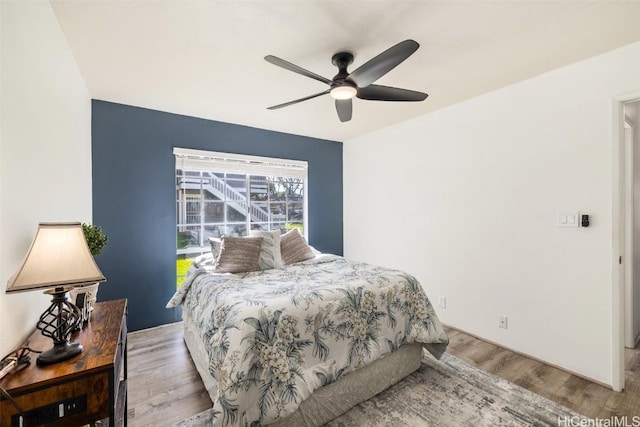 bedroom with ceiling fan and wood finished floors