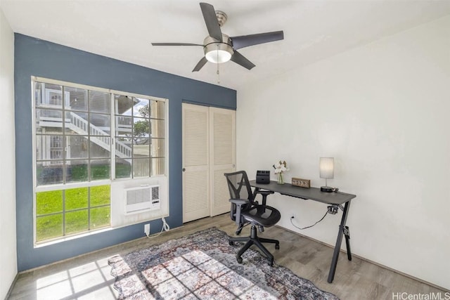 home office featuring a ceiling fan, wood finished floors, and a healthy amount of sunlight