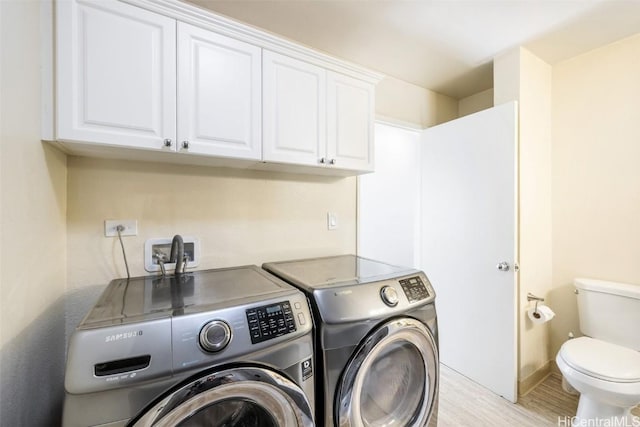 laundry area featuring washer and dryer, light wood-style flooring, and laundry area