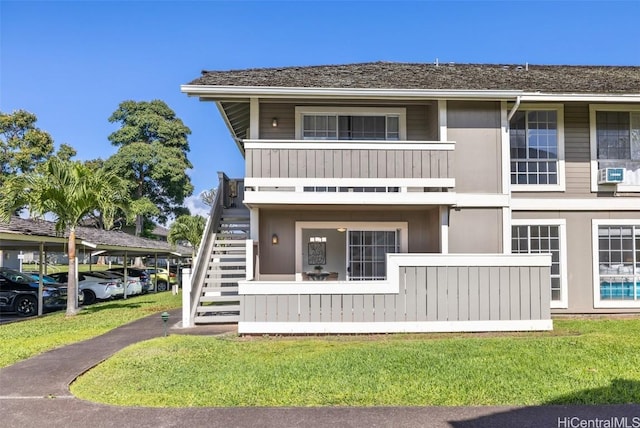 view of property featuring stairway and cooling unit