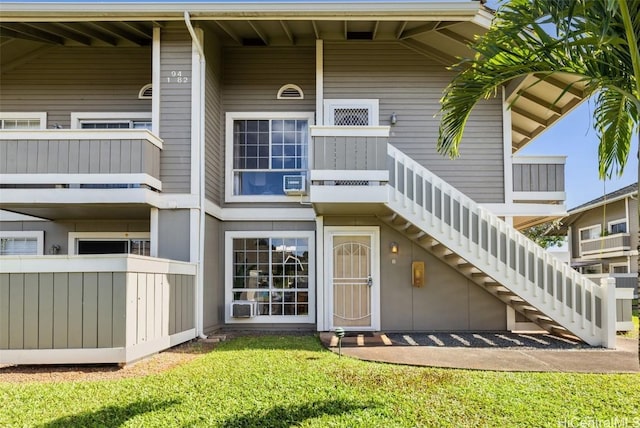 back of property featuring stairway