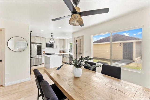 dining room featuring light wood-style flooring, recessed lighting, baseboards, and ceiling fan