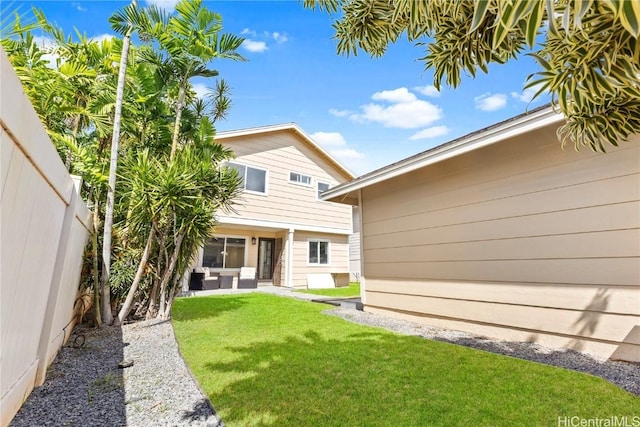 back of house featuring a patio, a lawn, and a fenced backyard