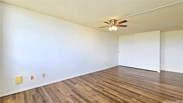 spare room featuring a ceiling fan, wood finished floors, baseboards, and a textured ceiling