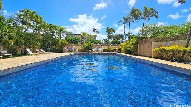 community pool featuring a patio area and fence