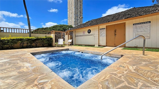 view of swimming pool with a patio area and fence