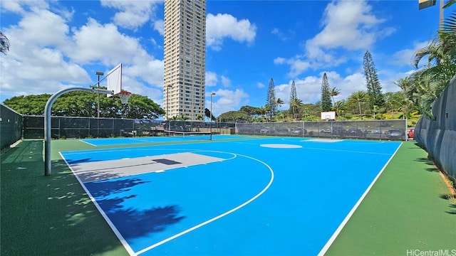 view of basketball court with community basketball court and fence