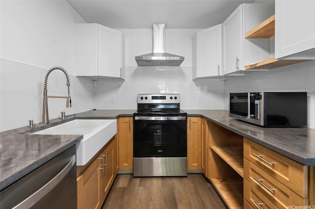 91-1018 Kaiau Ave Unit 1G, Kapolei, HI 96707 - kitchen with dark wood-style floors, open shelves, wall chimney range hood, appliances with stainless steel finishes, and white cabinetry