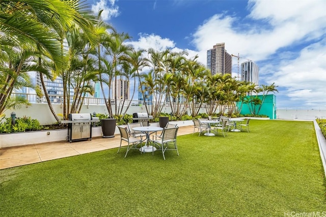 view of yard with a view of city and a patio area