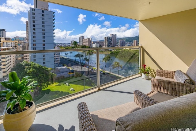 balcony featuring a view of city and a water view