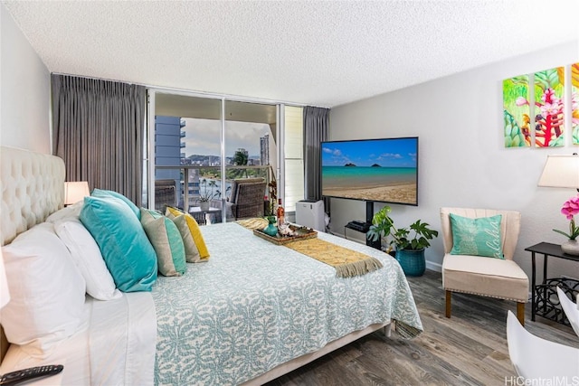 bedroom featuring a textured ceiling and wood finished floors