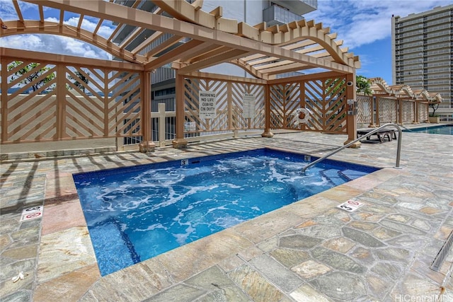 view of swimming pool featuring a community hot tub and a pergola