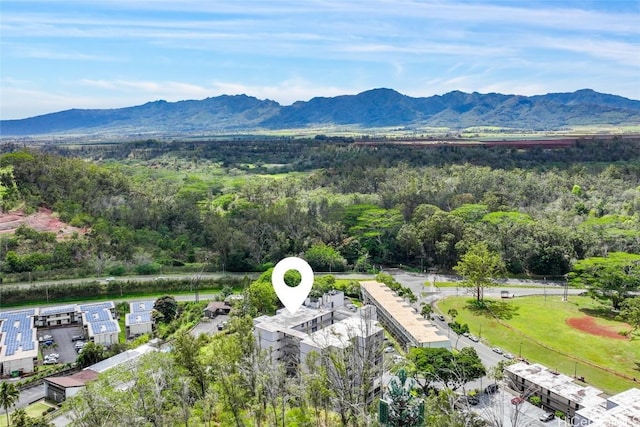 drone / aerial view with a wooded view and a mountain view