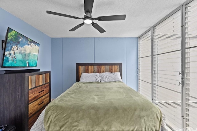 bedroom featuring a textured ceiling and ceiling fan