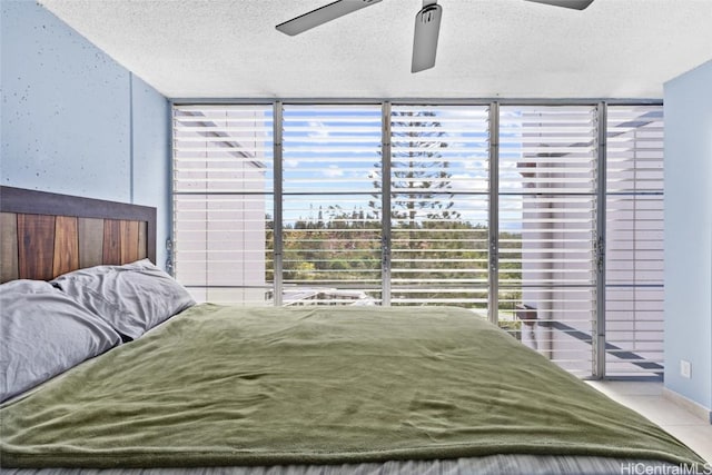 bedroom with a textured ceiling and ceiling fan