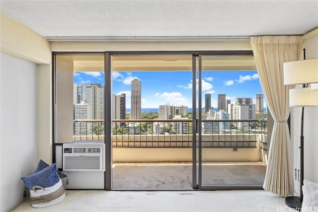 interior space with a city view, cooling unit, a wealth of natural light, and a textured ceiling