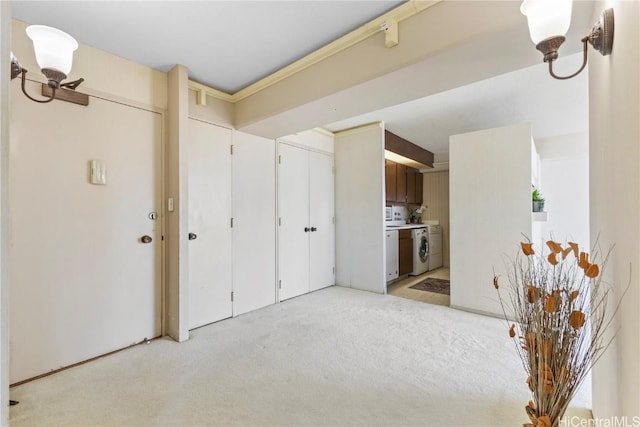 interior space featuring washer / dryer and light carpet