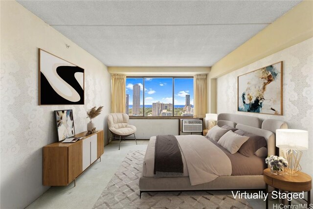 bedroom featuring light carpet, a view of city, and a wall mounted AC