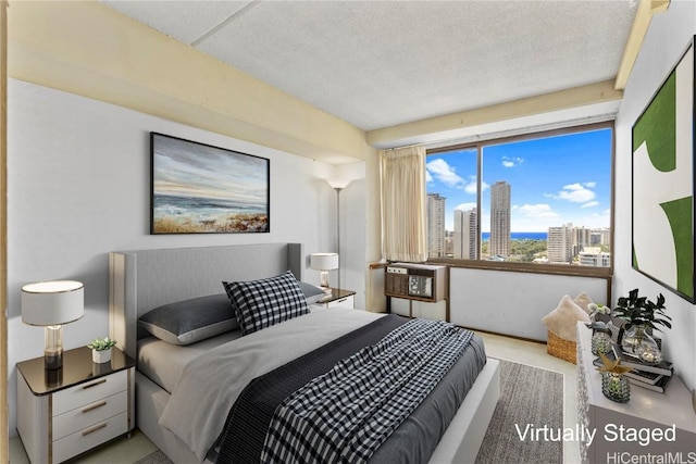 bedroom featuring a view of city and a textured ceiling