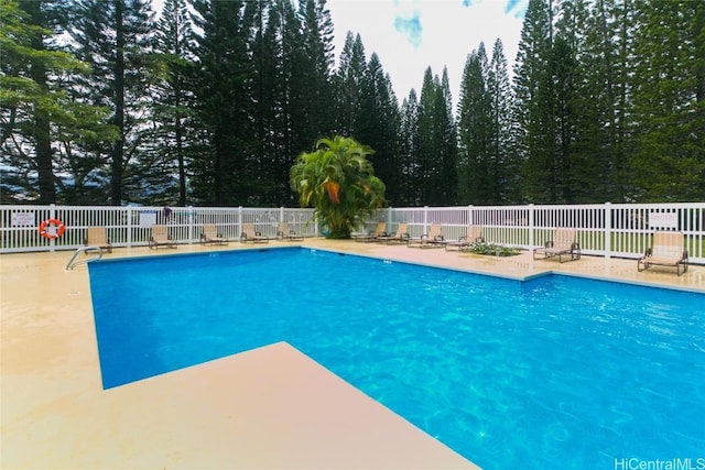 view of swimming pool with a patio area, fence, and a fenced in pool