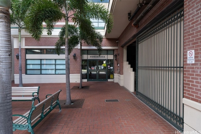 property entrance with brick siding and french doors