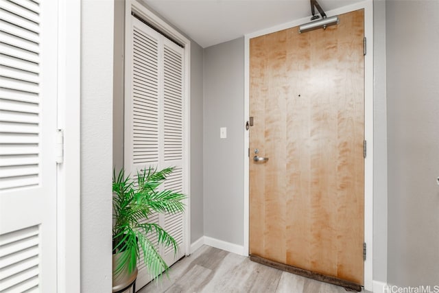 interior space featuring wood finished floors and baseboards