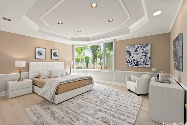 bedroom with a tray ceiling, light wood-style flooring, recessed lighting, and ornamental molding