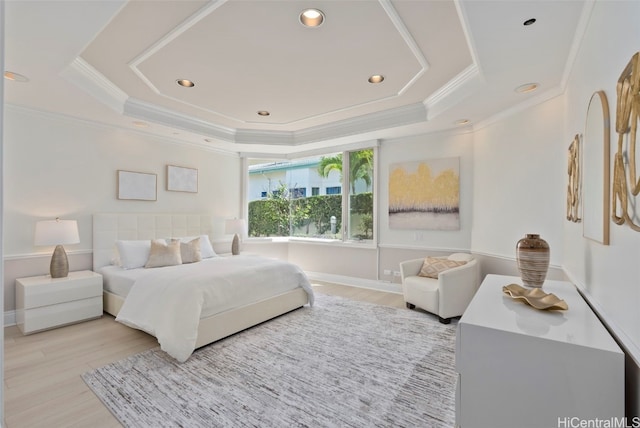 bedroom featuring recessed lighting, a raised ceiling, light wood-style floors, and ornamental molding