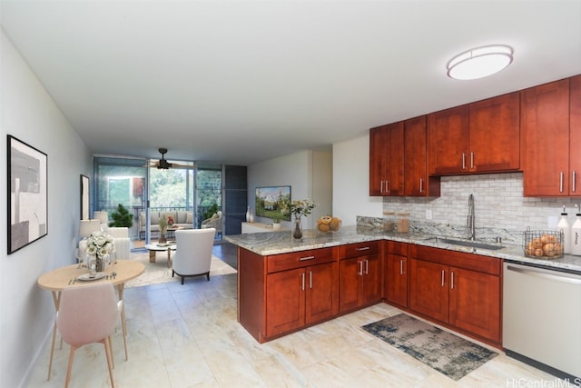 kitchen with light stone counters, decorative backsplash, a peninsula, stainless steel dishwasher, and a sink