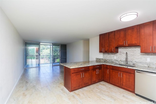 kitchen featuring stainless steel dishwasher, a wall of windows, tasteful backsplash, and a sink