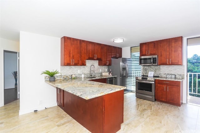 kitchen with reddish brown cabinets, backsplash, and stainless steel appliances