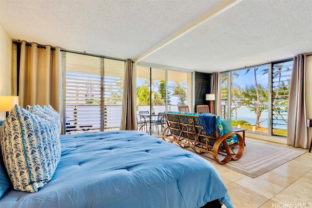 bedroom featuring tile patterned floors, a textured ceiling, and access to outside