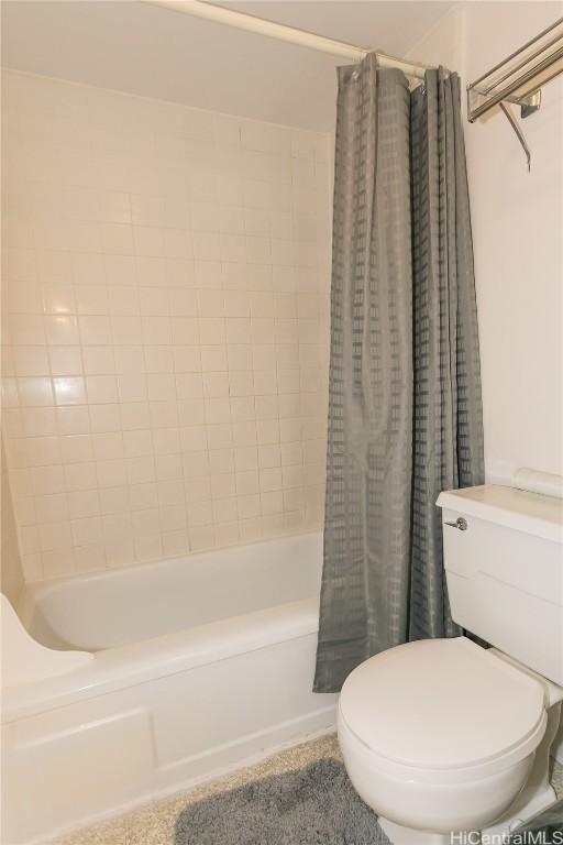 full bathroom featuring shower / tub combo and toilet