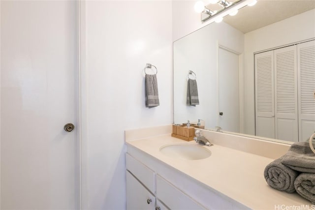 bathroom featuring a closet and vanity