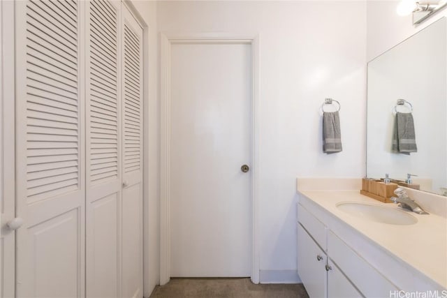 bathroom with vanity and a closet