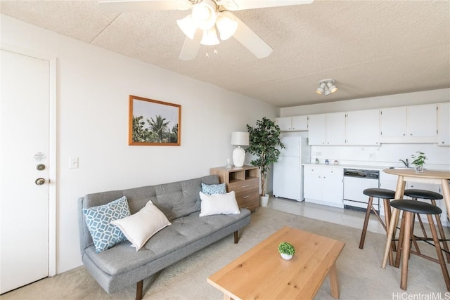 living room with a textured ceiling and ceiling fan