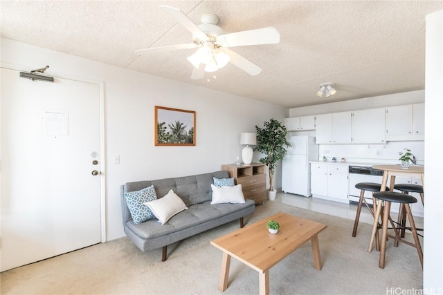 living area featuring a textured ceiling and ceiling fan