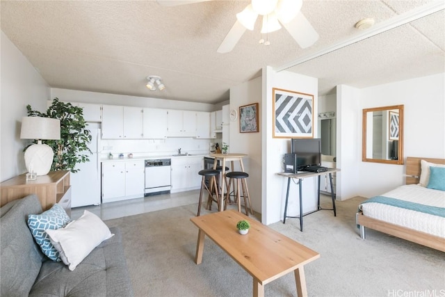 living room featuring a textured ceiling and ceiling fan