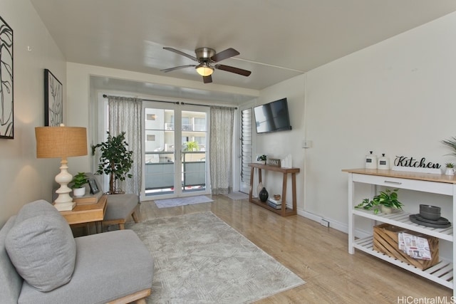 living room with french doors, wood finished floors, and a ceiling fan