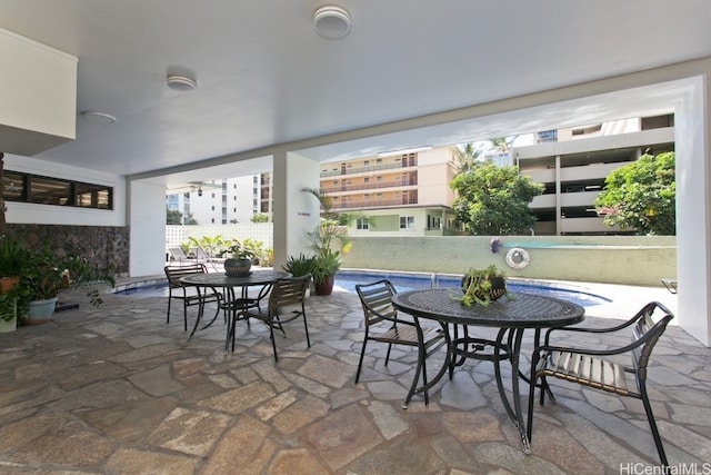 view of patio / terrace featuring outdoor dining area and a fenced in pool