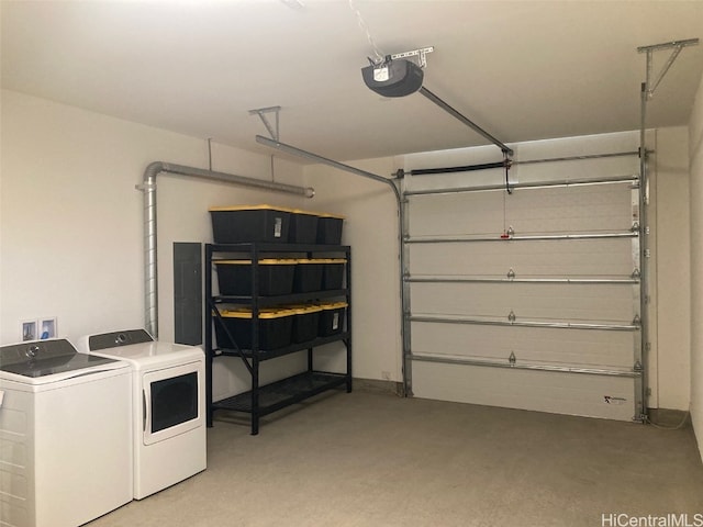 garage with a garage door opener and washing machine and dryer