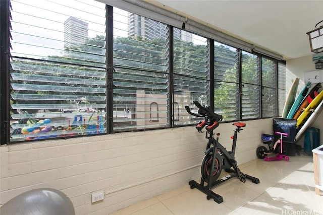 exercise room featuring tile patterned flooring