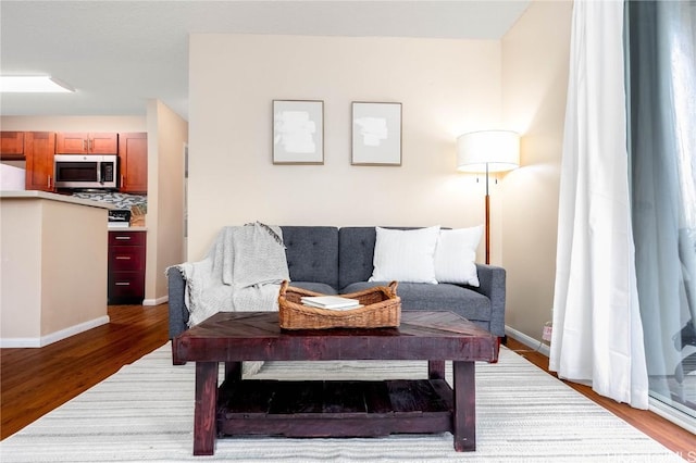 living area featuring wood finished floors and baseboards