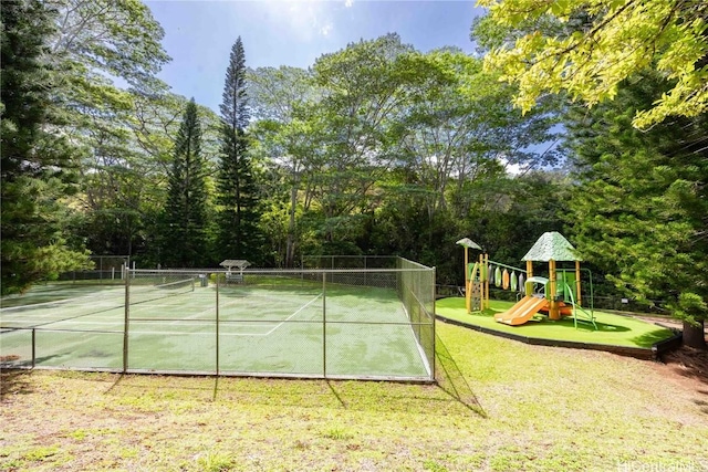 view of sport court with playground community, a yard, and fence