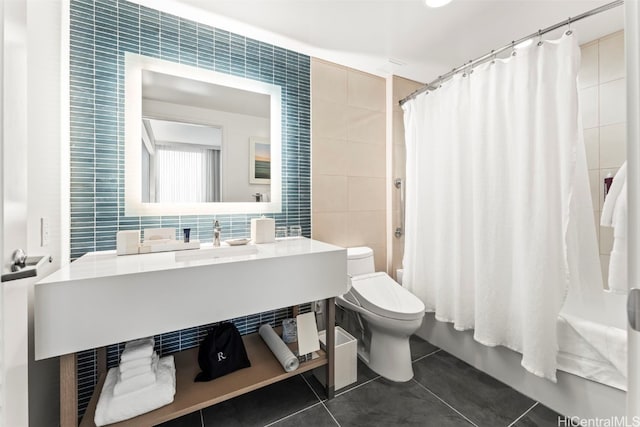 full bath featuring vanity, shower / bathtub combination with curtain, tile patterned flooring, tile walls, and toilet