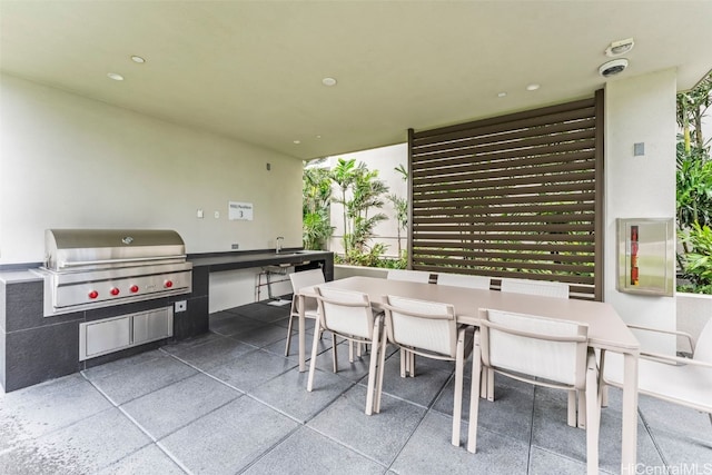 view of patio with area for grilling and outdoor dining space